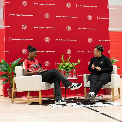 Sydney Moore ’24, left, speaks with Jennifer King, the first Black woman to be named to a full-time NFL coaching staff, May 3 at Newman Arena